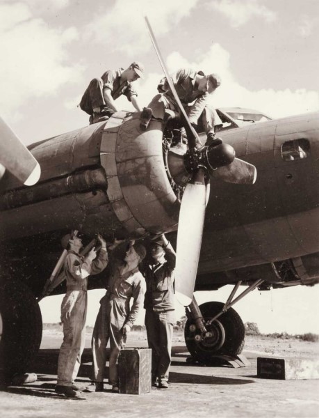 ground crew fixing an engine of a plane